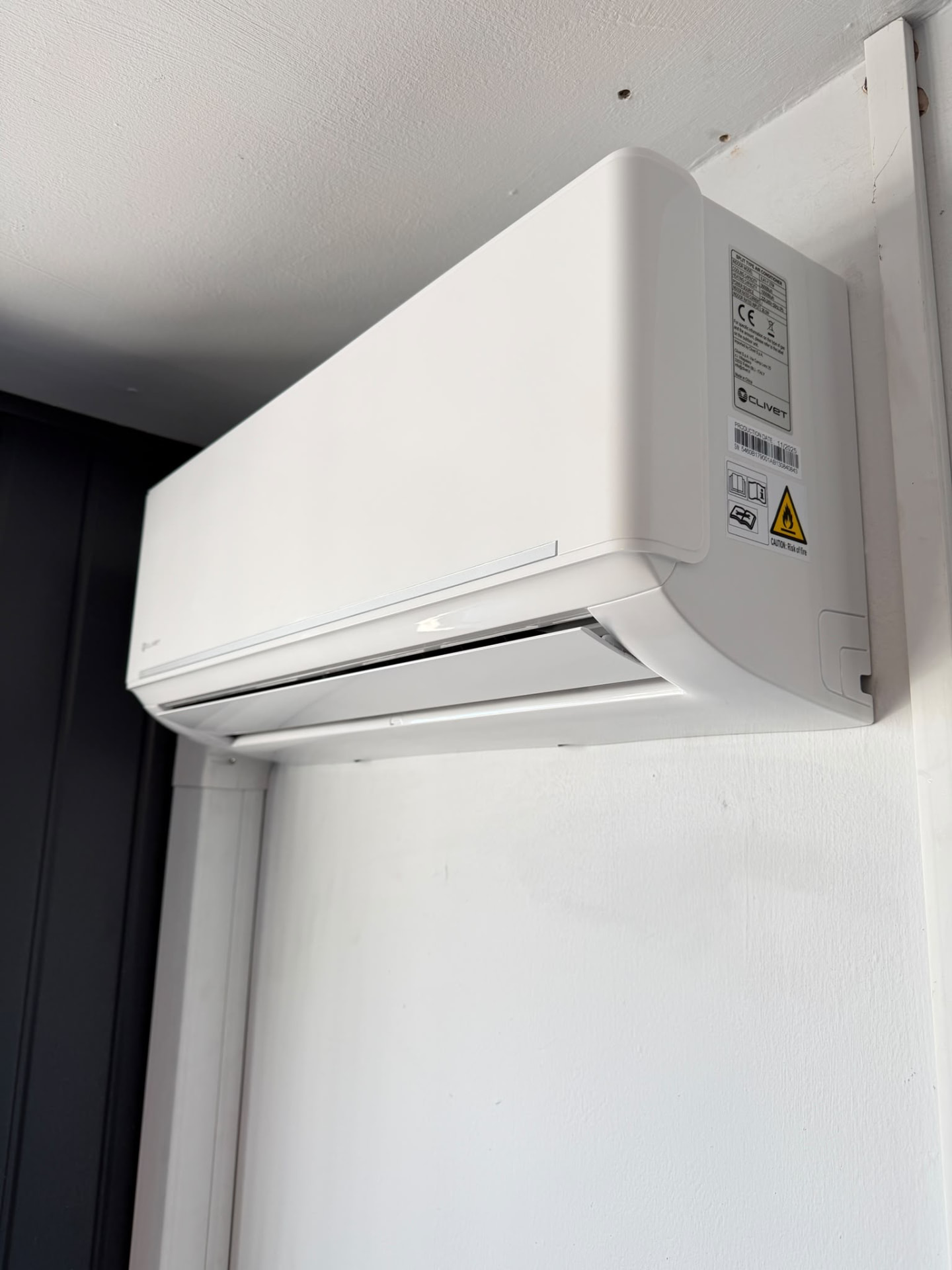 White Clivet wall-mounted indoor unit installed in one of the offices